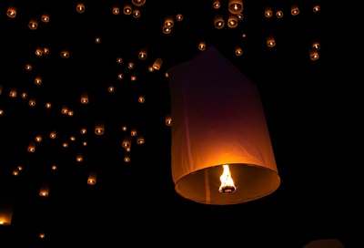 An image of lanterns in the night sky during the Loi Krathong Festival in Thailand.