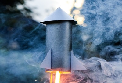 A homemade rocket launched in an empty field.