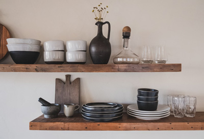 Useful kitchen items arranged on a shelf.