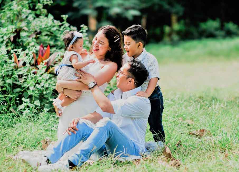 A photo of a Filipino family at a park.